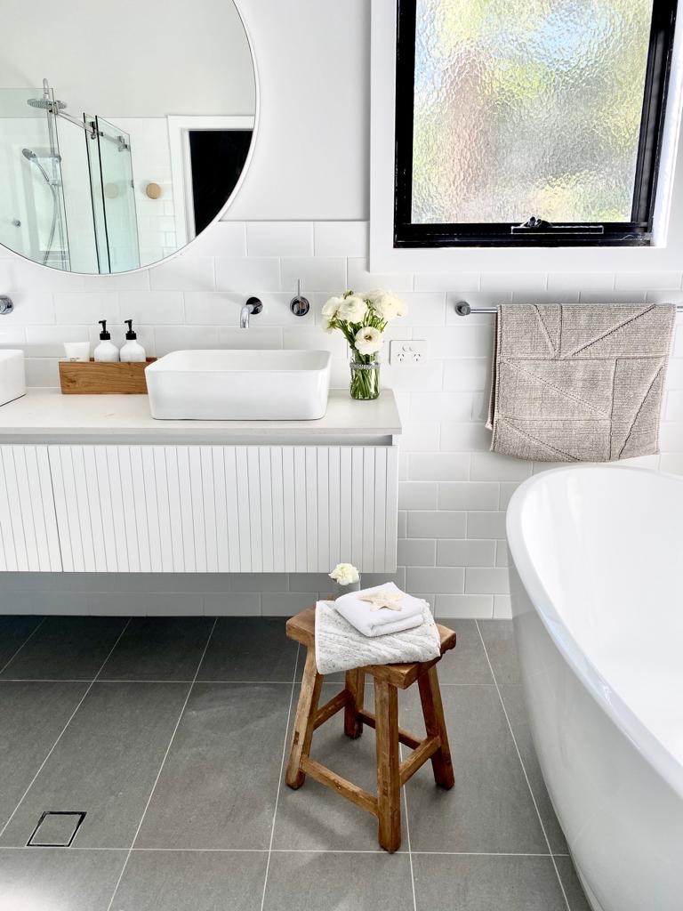 Bardon bathroom free-standing bath custom vanity grey floor tiles circle mirror