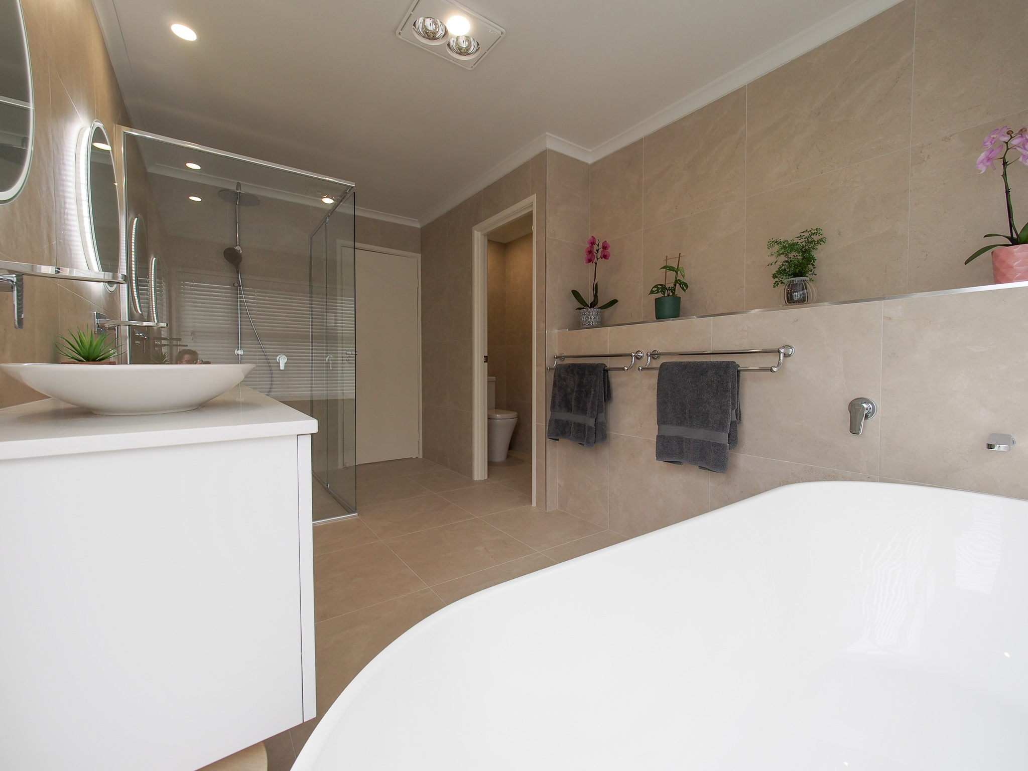 Travertine neutral beige tiles free standing bath double twin bowl vantity shower screen water closet